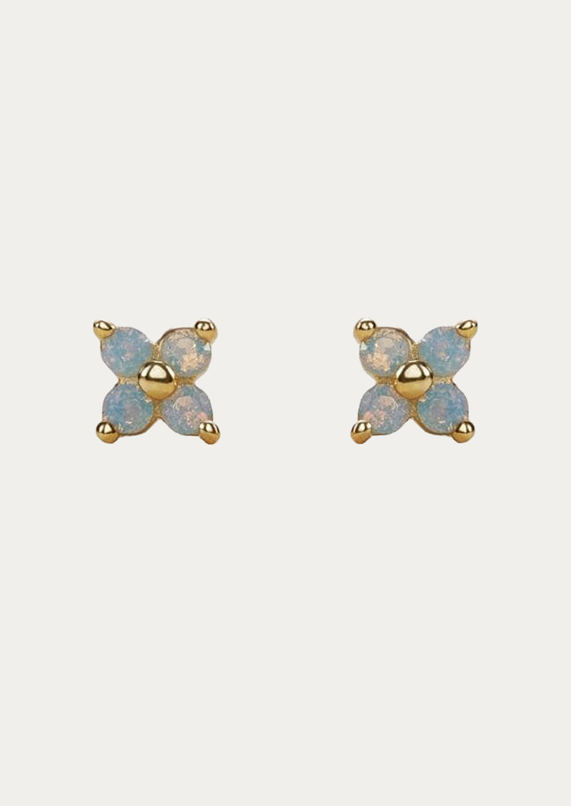 A pair of gold stud earrings with periwinkle flowers.