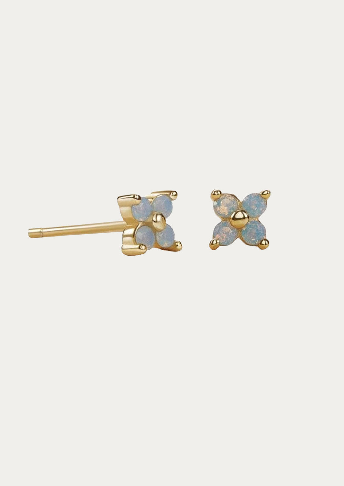 A pair of gold stud earrings with periwinkle flowers.