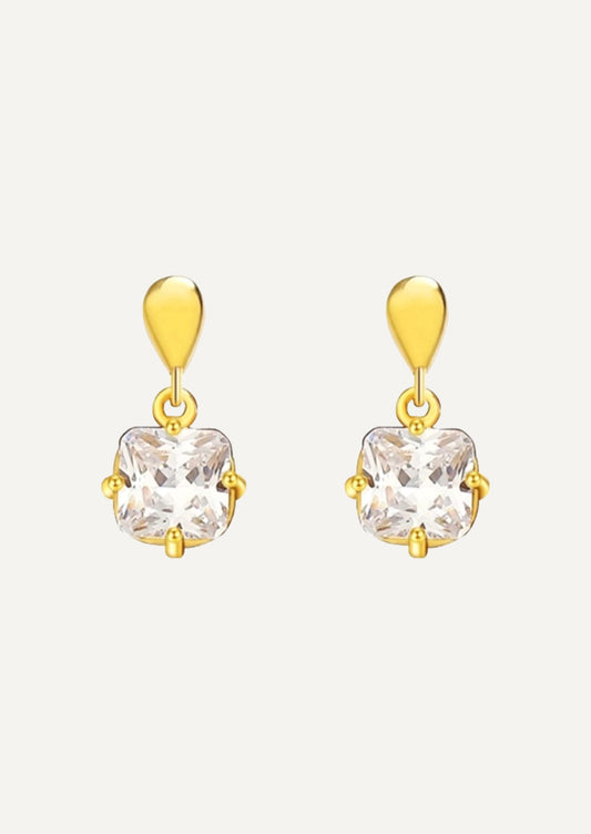 A pair of gold earrings with a princess cut cubic zirconia.