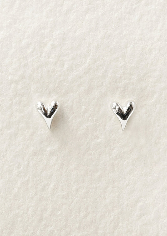 A pair of tiny sterling silver heart stud earrings.