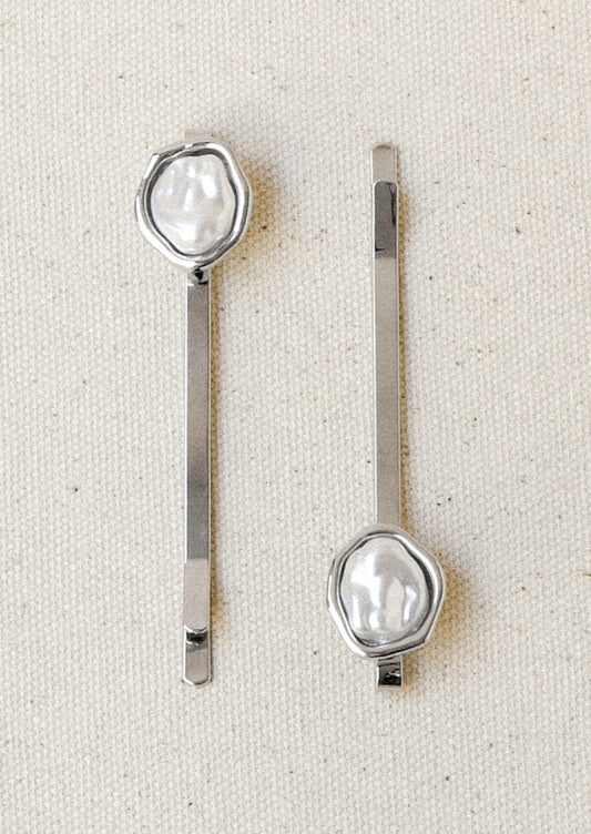 A set of 2 silver hair pins with a faux freshwater pearl on the end of each.