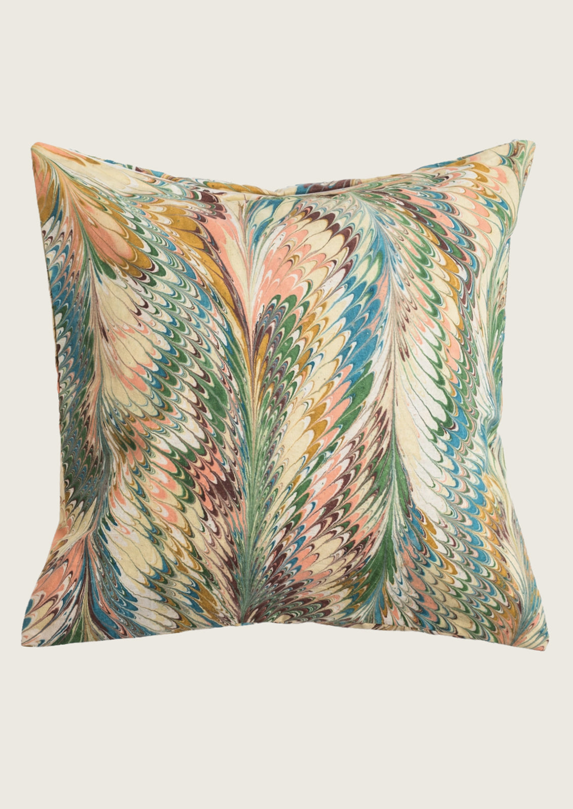 A square decorative throw pillow featuring a vibrant, multicolored feather-like pattern with shades of green, blue, pink, orange, and beige on a light cream background.