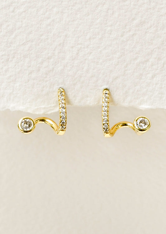 A pair of gold earrings in a unique sculpted design adorned with tiny cubic zirconias along the front.
