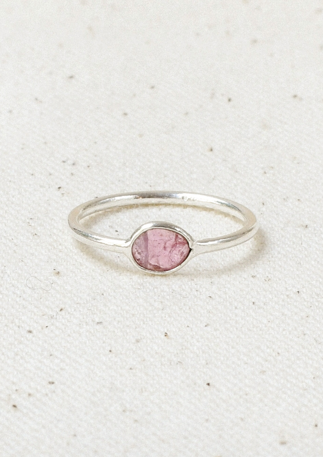 A sterling silver ring with a pink tourmaline  stone set in the center.