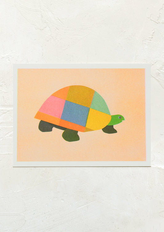 A risograph art print of multicolor turtle on peach background.