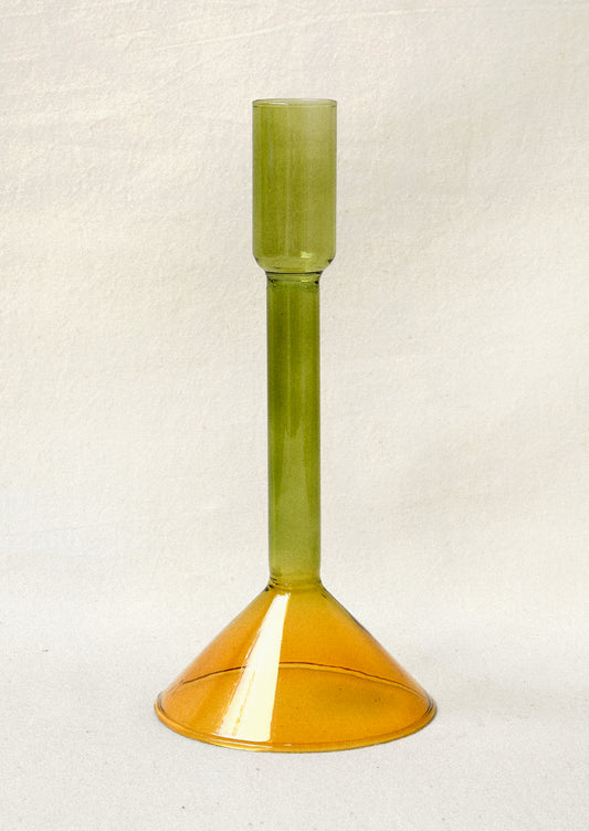 A two tone glass taper holder with a green stem and yellow base.