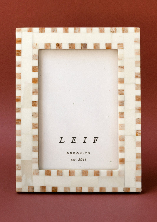 A 4" x 6" picture frame with a checkered design.