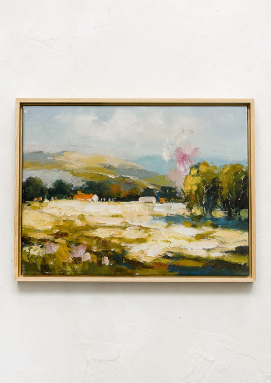 A framed original painting of colorful meadow/vista.