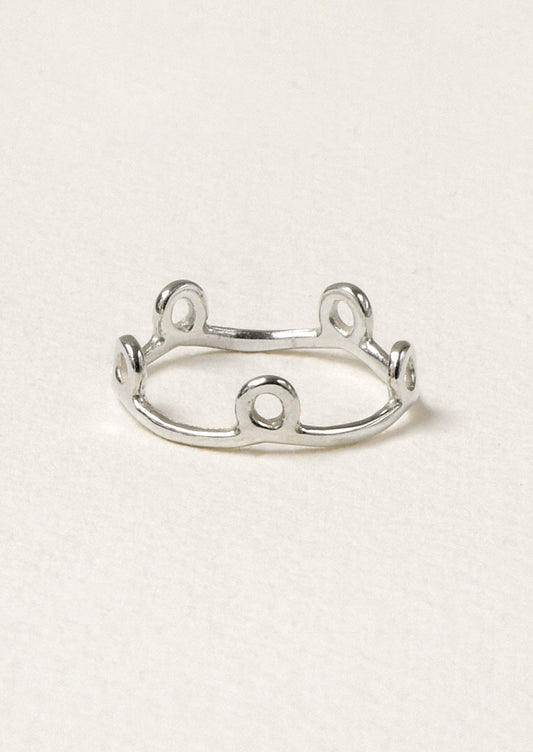 A sterling silver ring with small circles along the band.