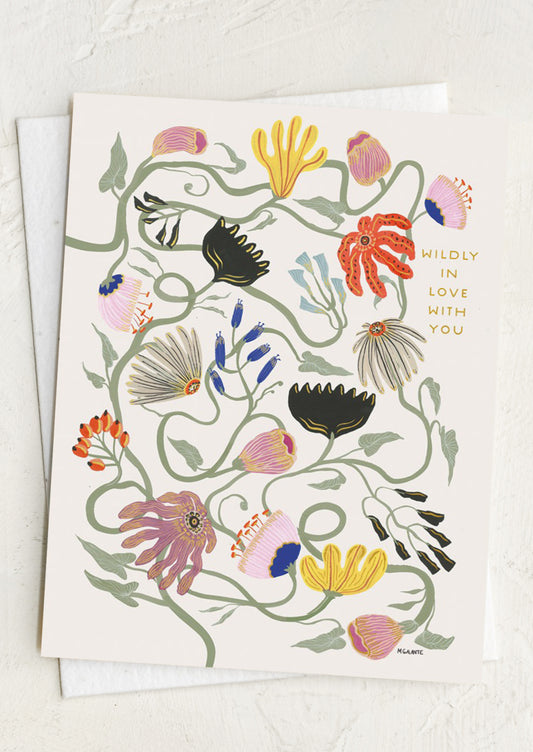 Greeting card with floral design and text on a white background reading "Wildly in love with you".