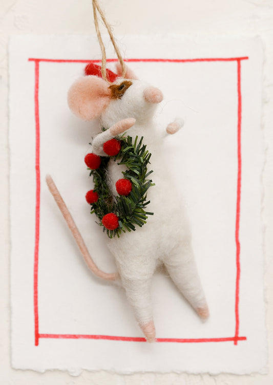 A felted mouse ornament, mouse is holding a holiday wreath.