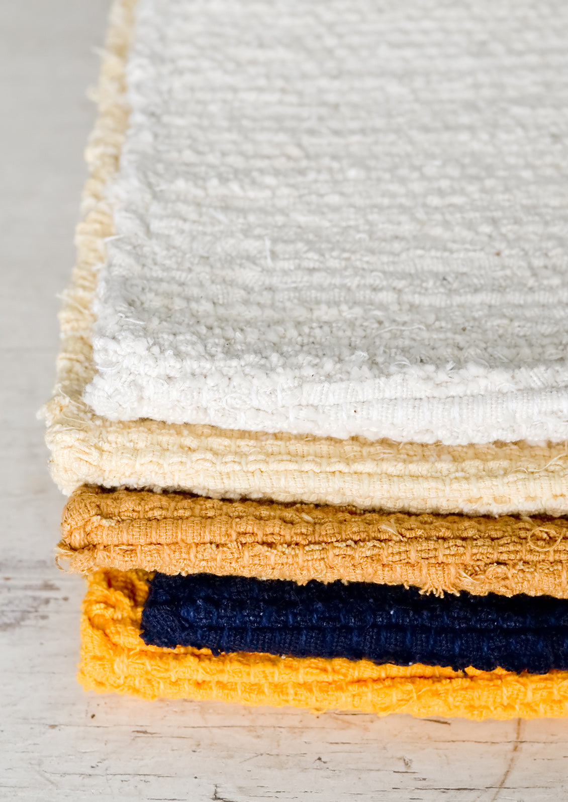 A stack of textured rugs.
