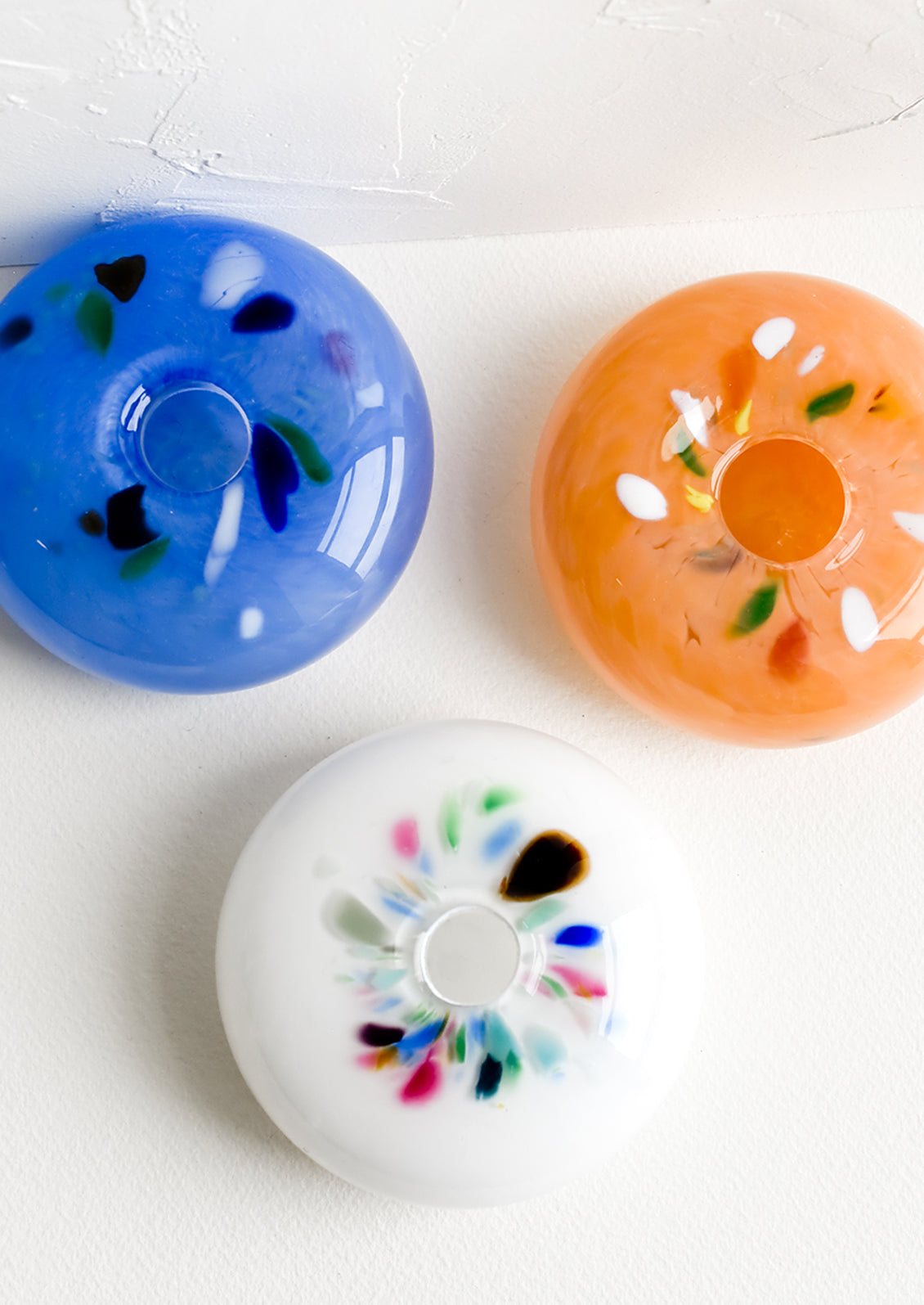 Glass bud vases with colorful fleck detail around opening.