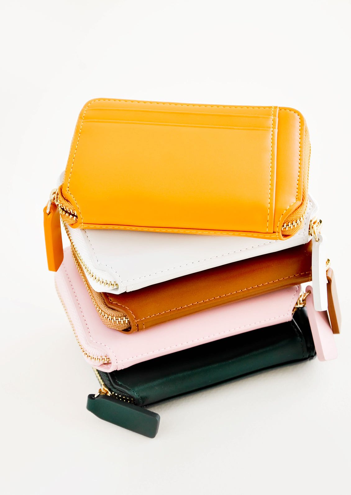 Stack of colorful leather zip wallets.