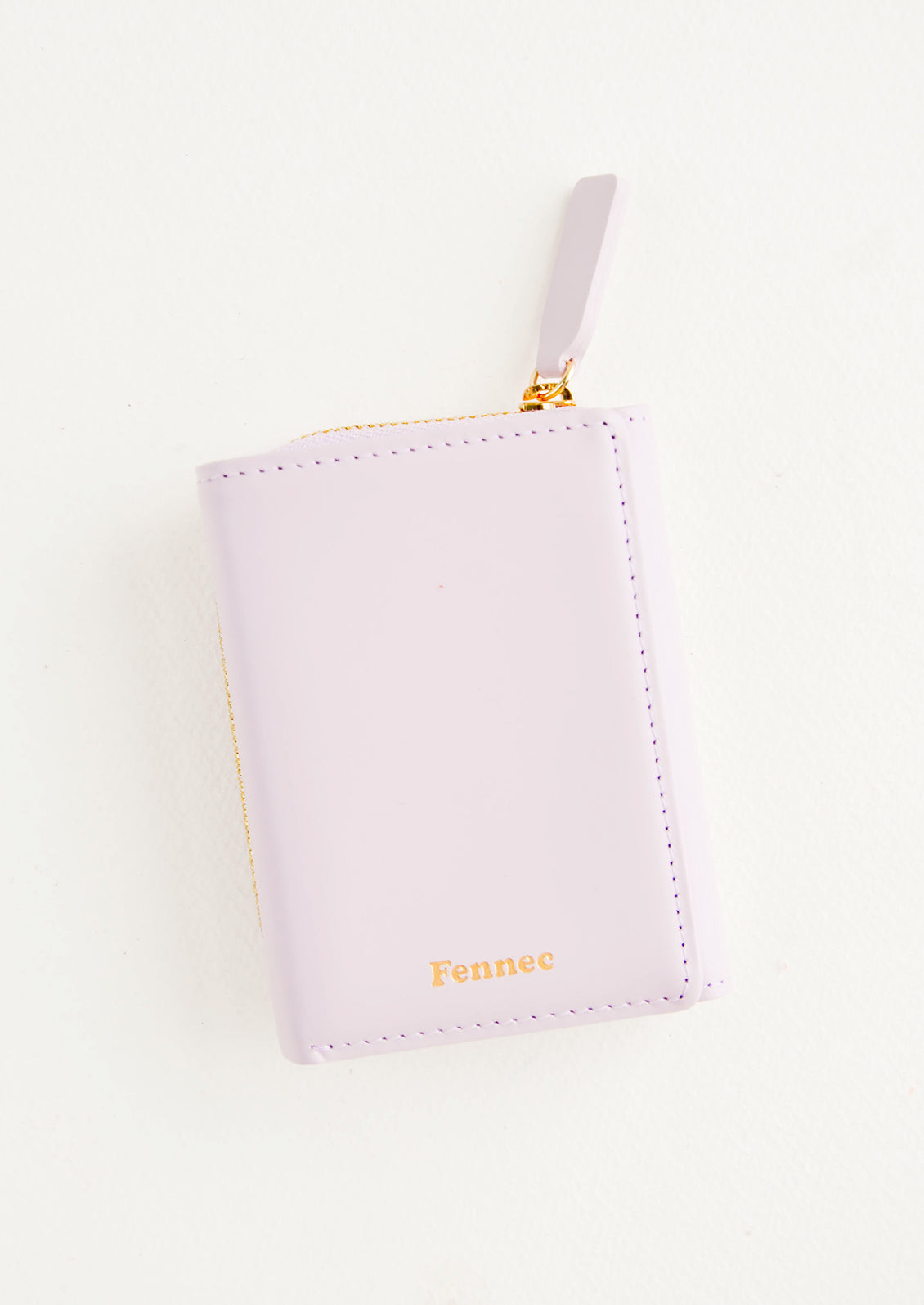 Violet leather wallet that zips on three sides, in a closed position, with matching tab pull.