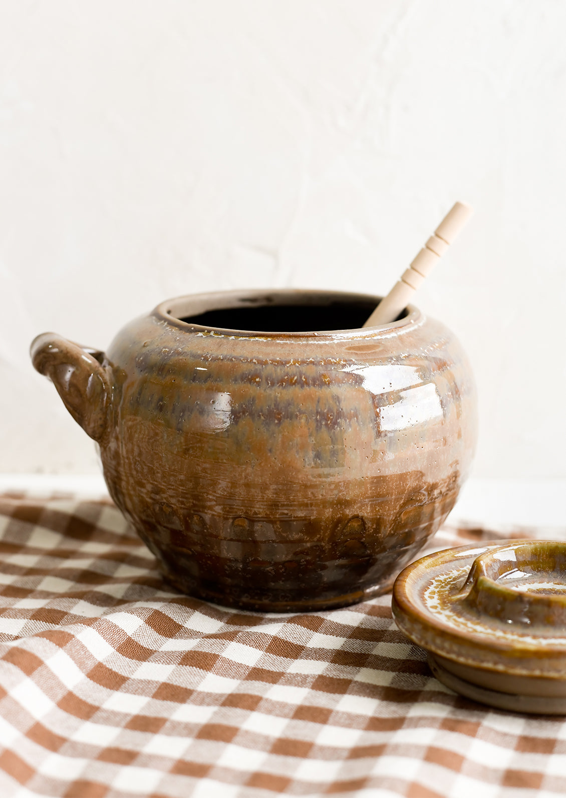 A brown ceramic honey jar.
