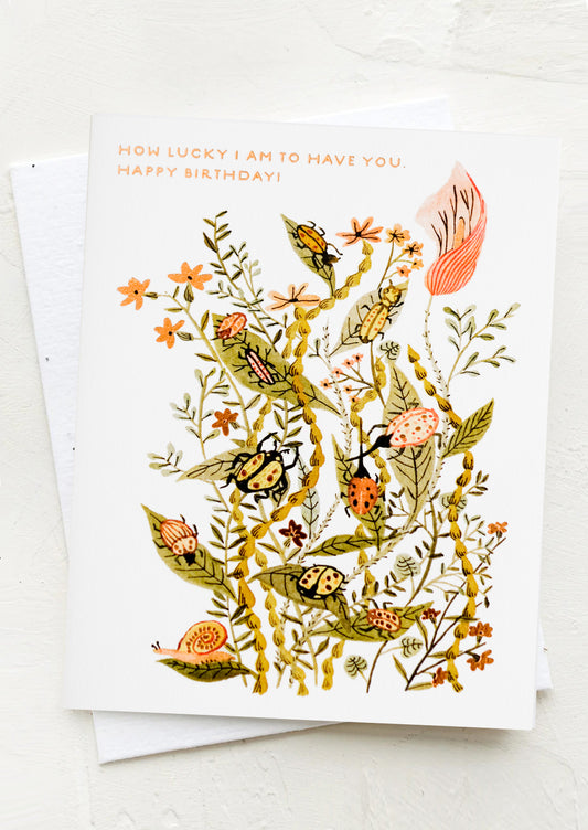 A card reading "How lucky I am to have you. Happy Birthday!", with illustration of insects on leaves.