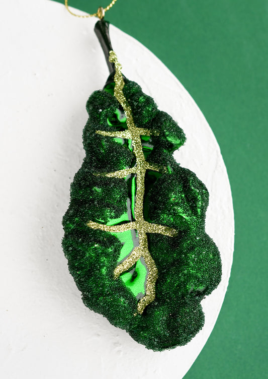 A holiday ornament of a leafy kale piece.