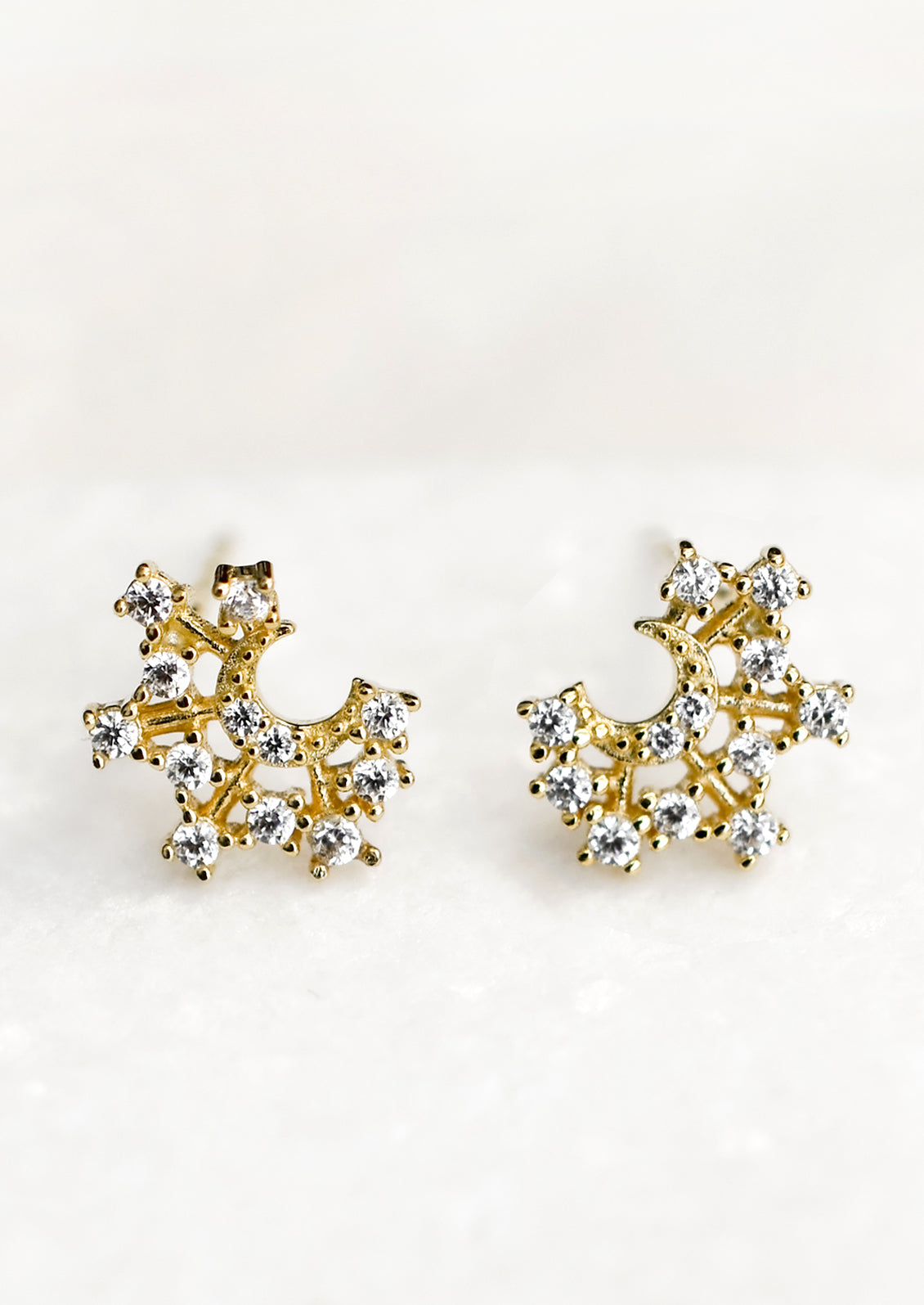 Crystal moon shaped gold stud earrings.
