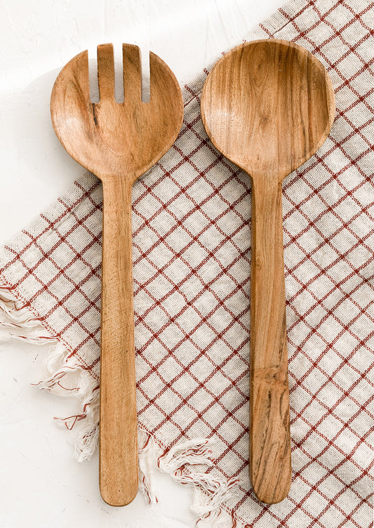 A pair of acacia wood salad servers with simple, plain design.