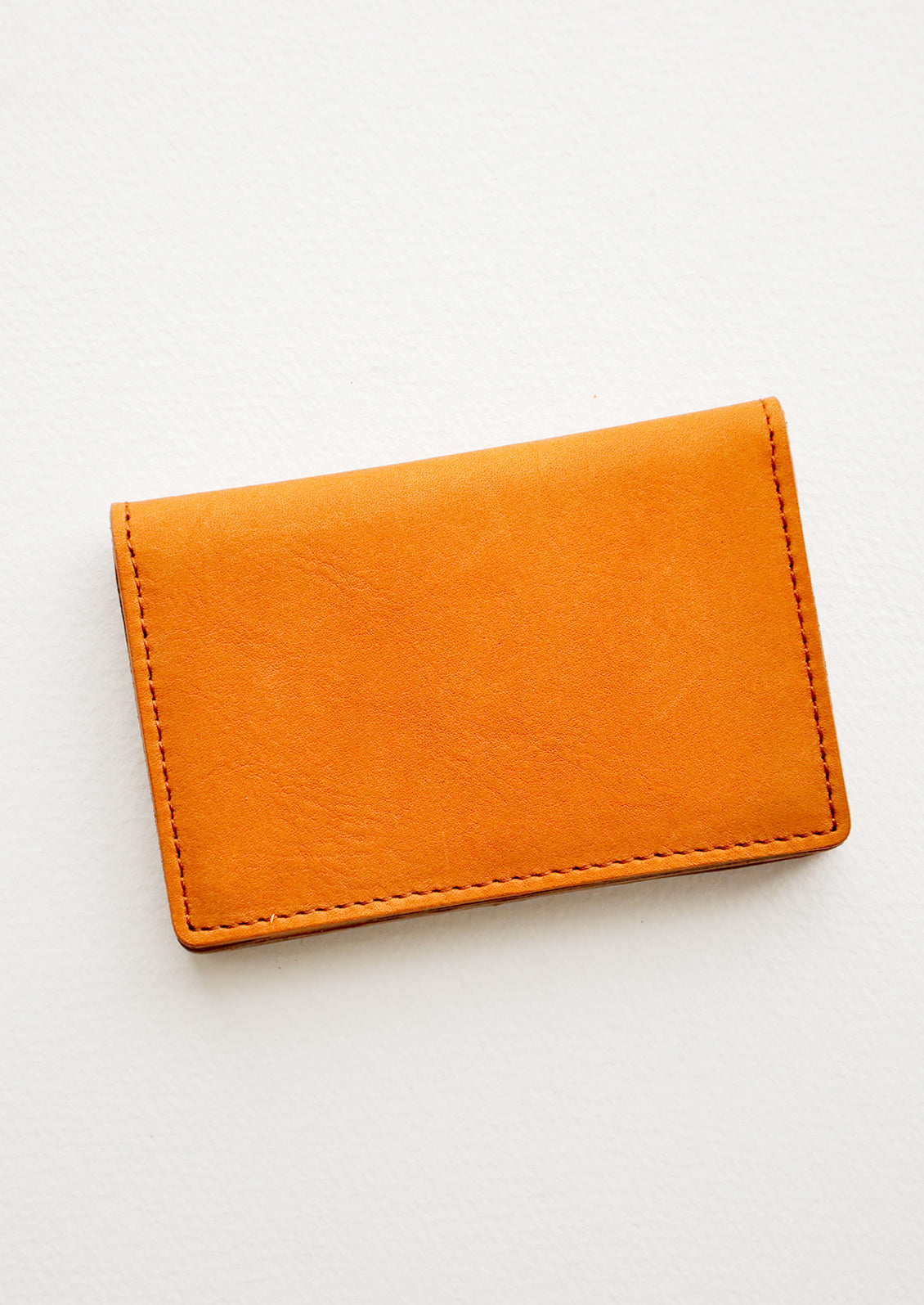 A small leather cardholder wallet in tanned leather.