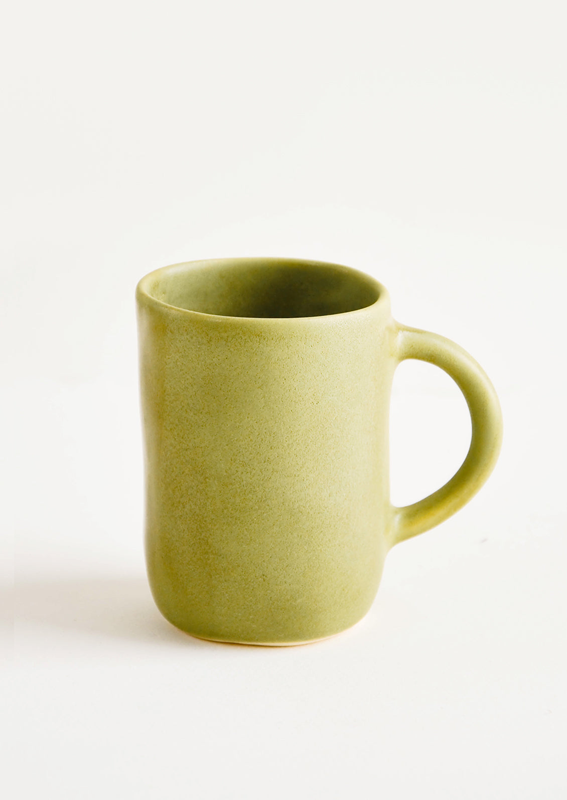 Ceramic mug with handle, shown in matte avocado green glaze.