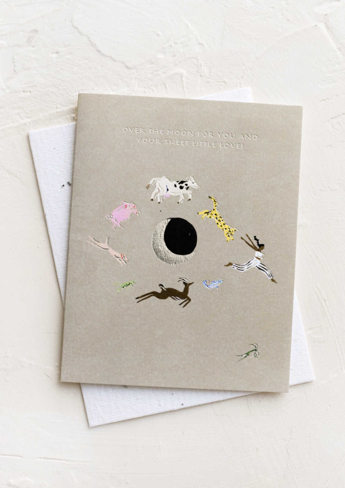 A greeting card with animals rotating around moon.