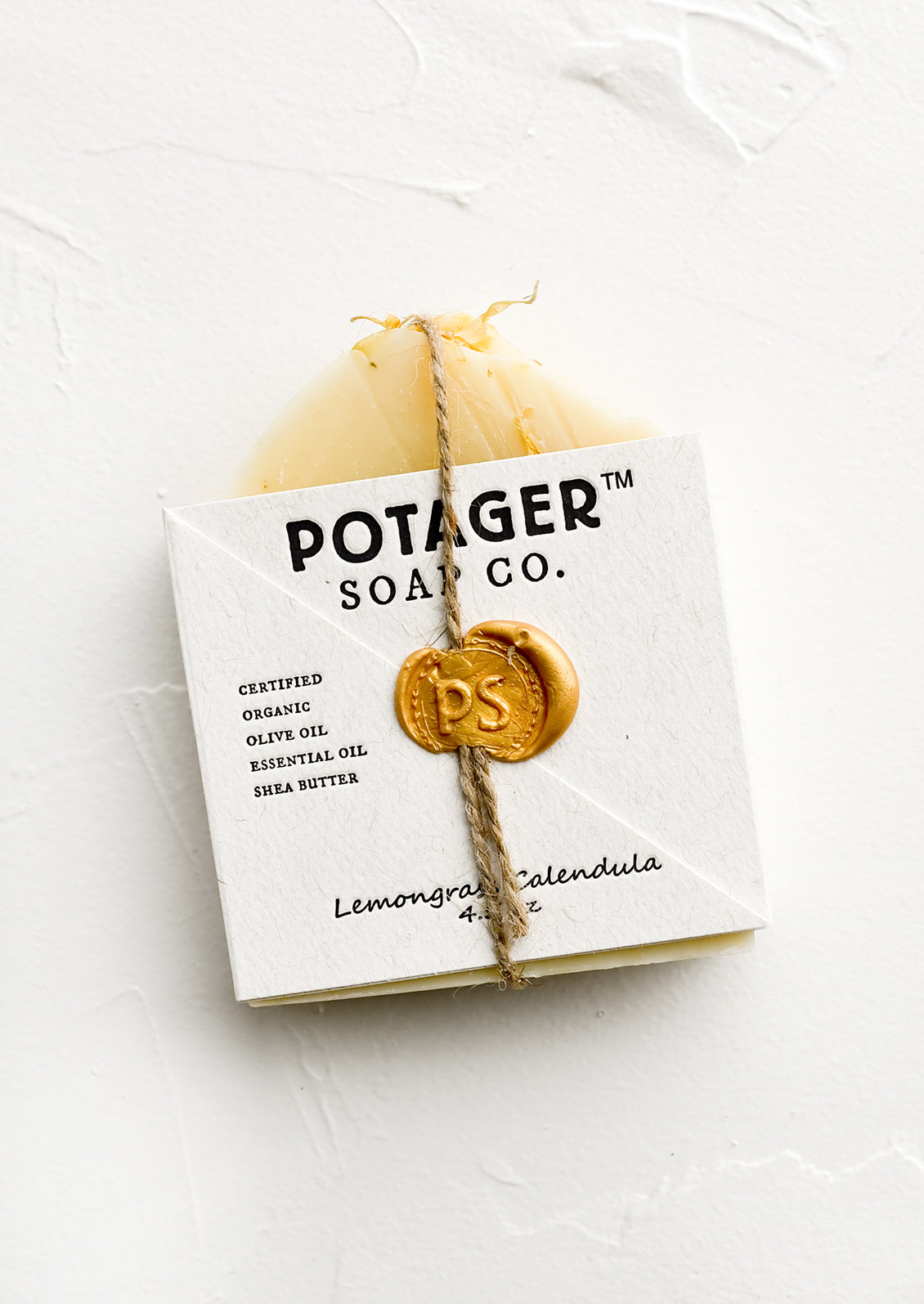 A bar soap in wax seal packaging.