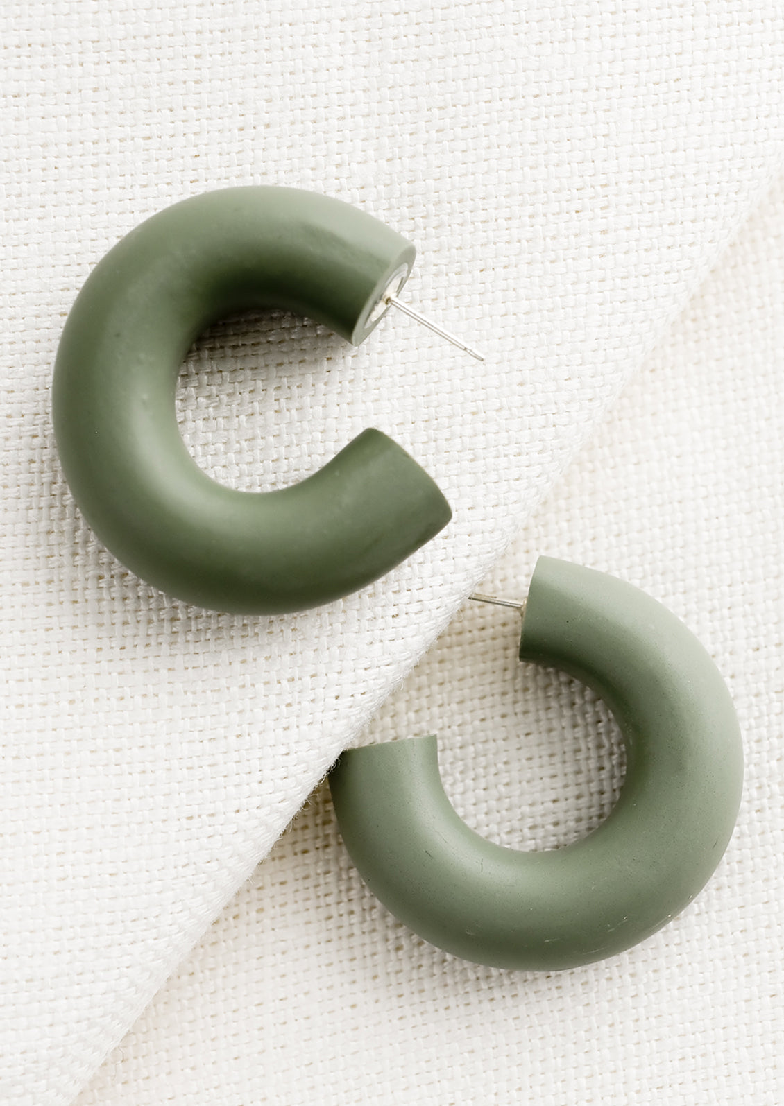 A pair of polymer clay hoop earrings in aloe green..