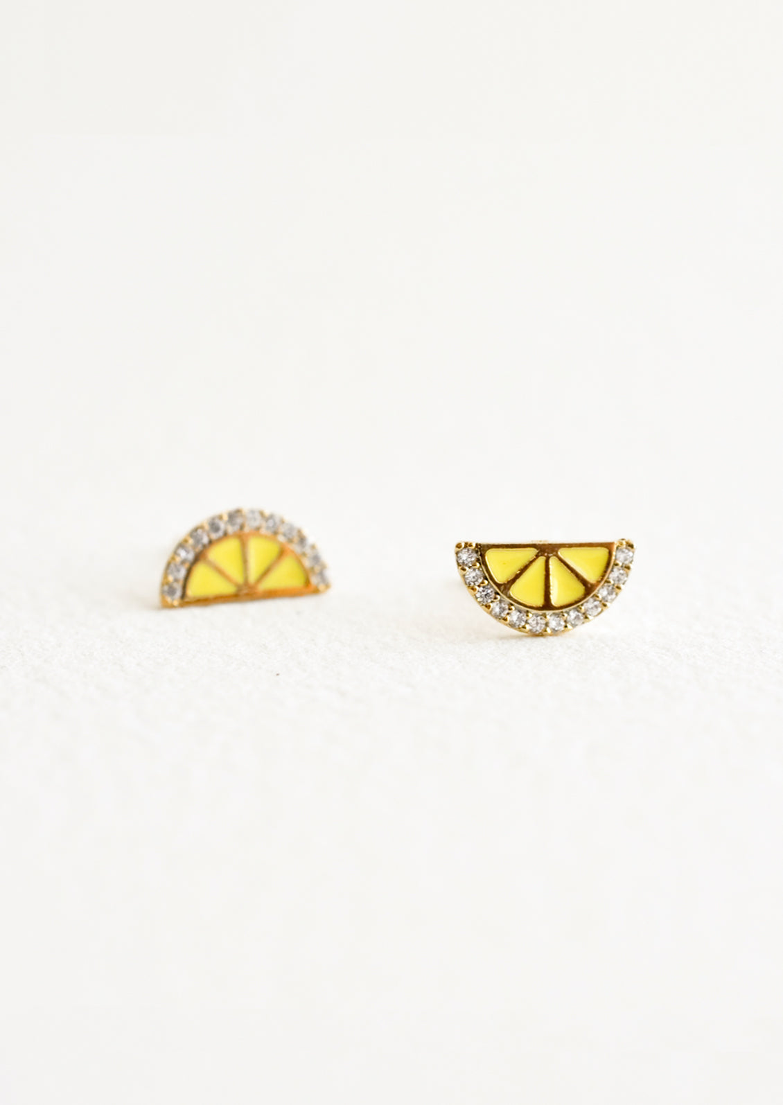 Stud earrings in the shape of a lemon wedge with crystal "rind".