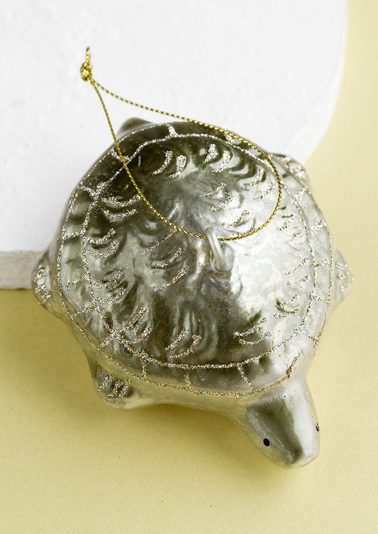 A glass holiday ornament of a turtle.