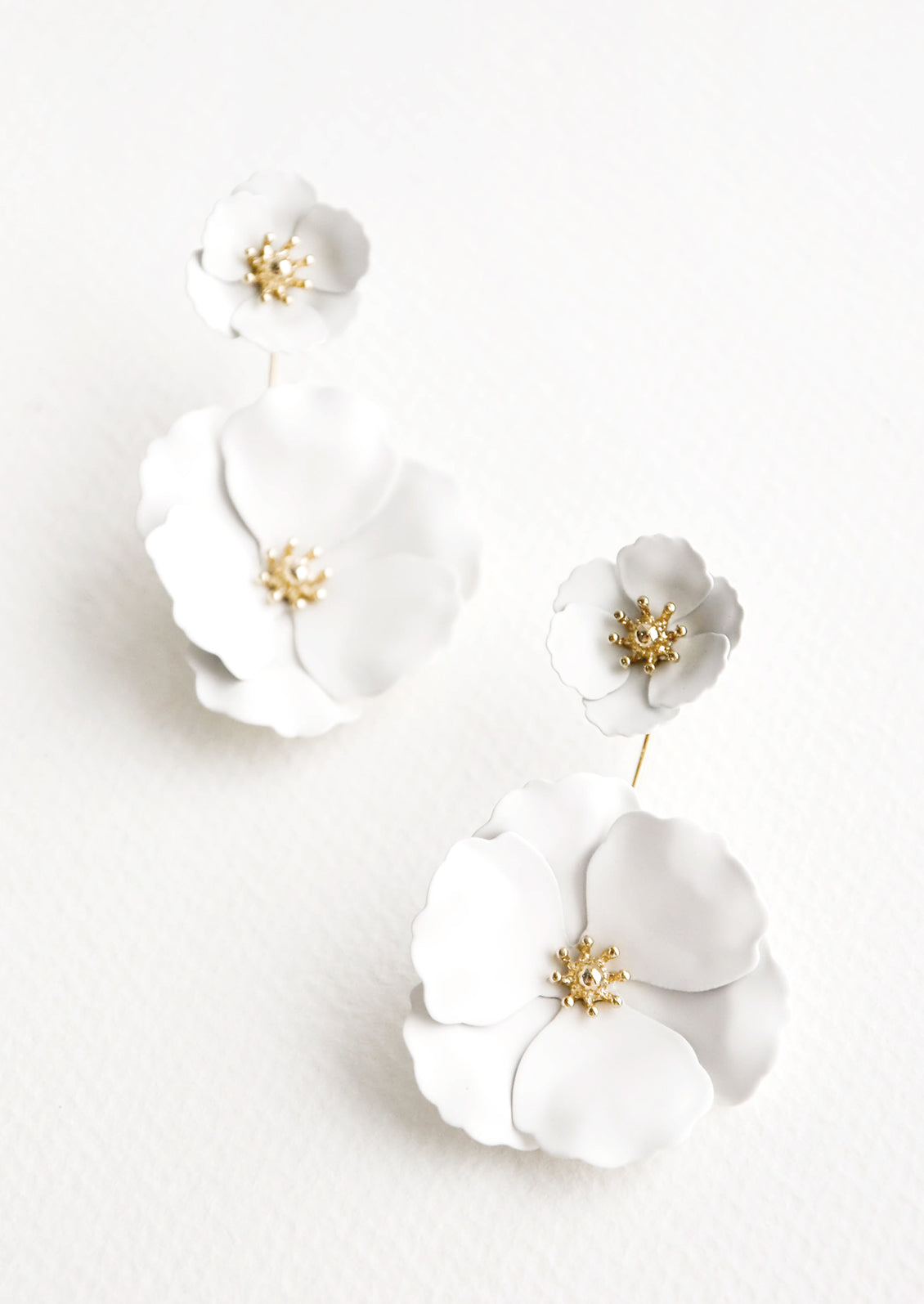 Two part true white and gold flower earrings with a small flower post and larger flower drop. 